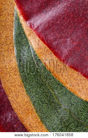 Tklapi - dried mashed fruit pulp / Colorful fruit leather from apricot kiwi dogwood. Georgian and Armenian cuisine. Food background.