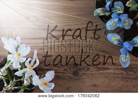 Wooden Background With German Text Kraft Tanken Means Relax. Sunny Spring Flowers Like Grape Hyacinth And Crocus. Aged Or Vintage Style