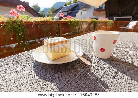 Traditional dessert with cup of coffee on sunny terrace. The image was taken in Bled Slovenia.