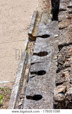 Ancient public toilets along the central road in Dion archaeological park, Pieria, Greece.