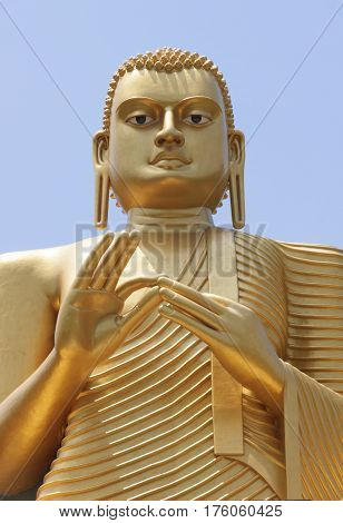Statue of golden buddha in golden temple Dambulla Sri Lanks close view