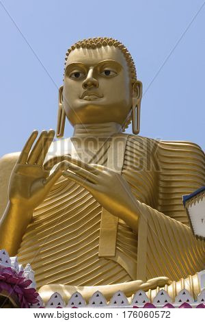 Statue of golden buddha in golden temple Dambulla Sri Lanks close view vertical