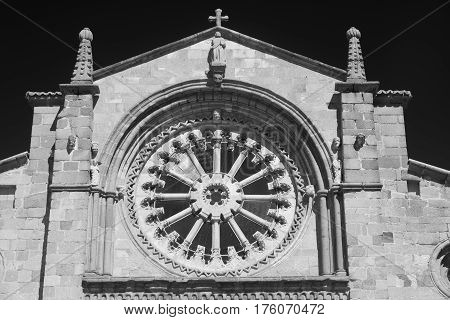 Avila (Castilla y Leon Spain): facade of the historic Santa Teresa church: rose window. Black and white