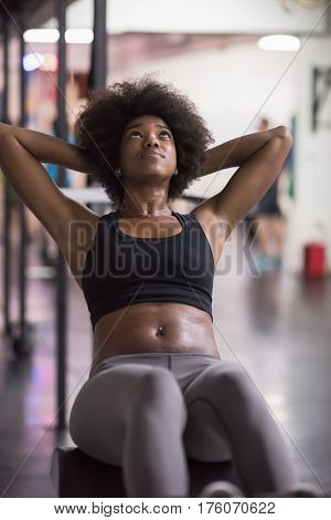young fit african american woman doing sit ups in fitness studio at the gym.Abdominal exercises Sit up