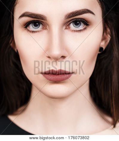 Close-up portrait of young beautiful woman's face with eloquent eyes.
