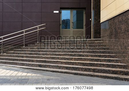 Stairs to entrance in modern building.                             