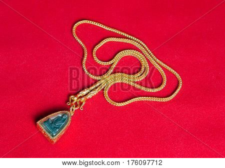 Gold Necklace 96.5 Percent Thai Gold Grade With Buddha And Gold Frame Pendant Isolated On Red Flanne