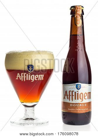 GRONINGEN, NETHERLANDS - MARCH 10, 2017: Bottle and glass of Belgian Affligem Double beer isolated on a white background