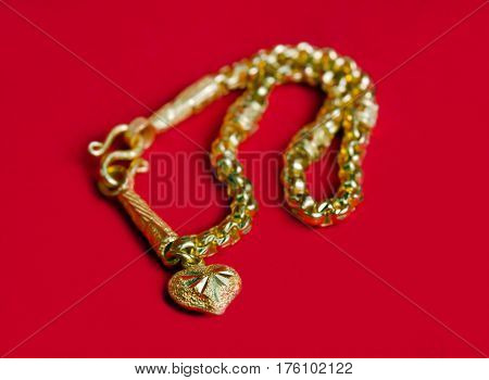 Gold Necklace 96.5 Percent Thai Gold Grade With Gold Heart Pendant Isolated On Red Flannel Cloth Bac