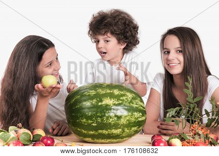 Happy family with a huge whole watermelon on white background