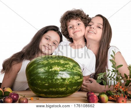 Happy smiling children with huge watermelon on white background