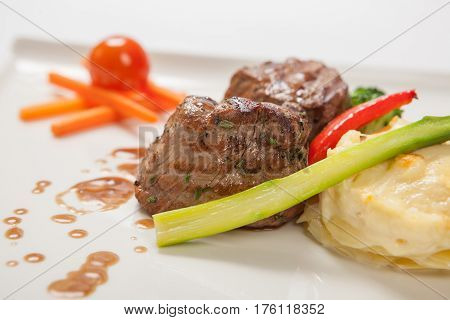 Medallions Of Grilled Veal With Gratin Potatoes Close Up