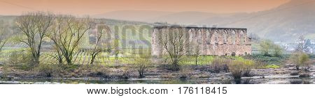 Artistic work of my own. HDR processing. Panorama ruins of a monastery in bars on the Moselle in the background the vineyard. Shot in the morning fog.