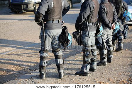 Police In Riot Gear With Flak Jackets And Protective Helmets And