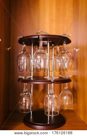 Glasses hanging upsidedown in wine bar interior