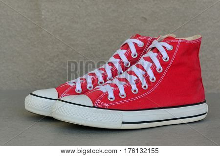 close up vintage style of sport red sneaker shoe on gray background