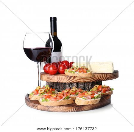 Tasty bruschetta served with wine on white background