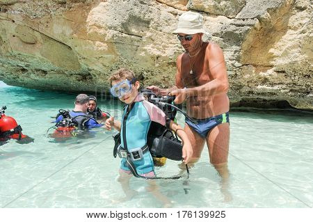 Child Discover Scuba Diving At Cala Mariolu Beach On Sardinia