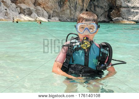 Child Discover Scuba Diving At Cala Mariolu Beach On Sardinia