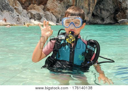 Child Discover Scuba Diving At Cala Mariolu Beach On Sardinia
