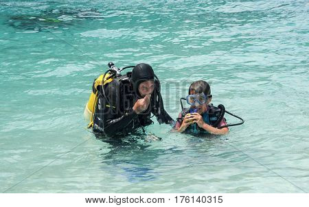 Child Discover Scuba Diving At Cala Mariolu Beach On Sardinia