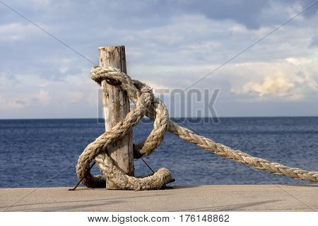 Rope On Seafront And Cloudy Sky In Sun Autumn Day