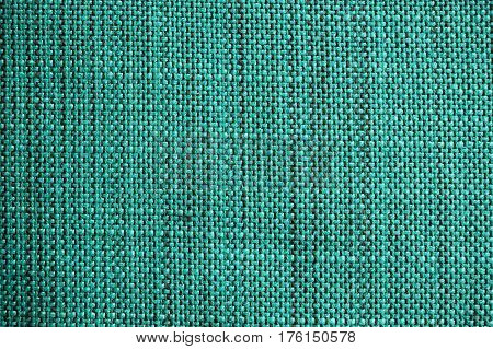 Turquoise fabric texture. Turquoise cloth background. Close up view of turquoise fabric texture and background. Abstract background and texture for designers.