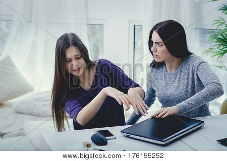 Scared mother arguing daughter over online activity. Cyber bullying or blue whale game concept