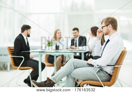 lawyer of the company on the background of the working meeting the business team.the photo has a empty space for your text