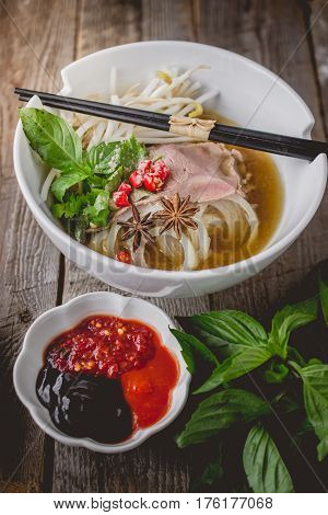 Pho Vietnamse Noodle Soup on Old Wood. Image for Food Advertise Concept
