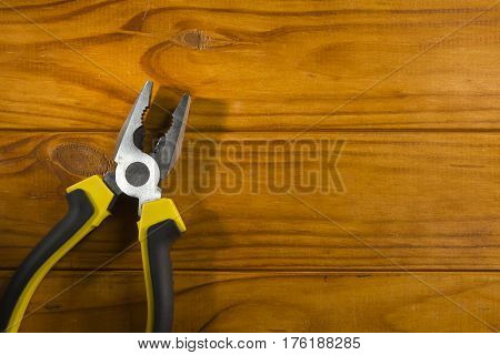 Close up of a multitool pliers on wooden background