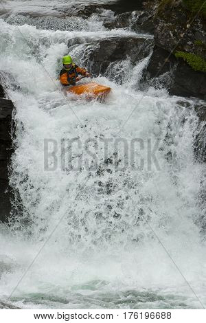 Kayaker in the waterfall in Norway Ula river
