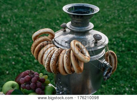 A Samovar With A Bunch Of Bagels Hanging On It