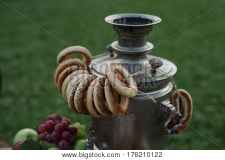 A Samovar With A Bunch Of Bagels Hanging On It
