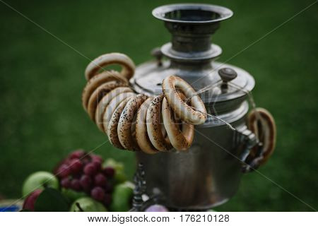 A Samovar With A Bunch Of Bagels Hanging On It