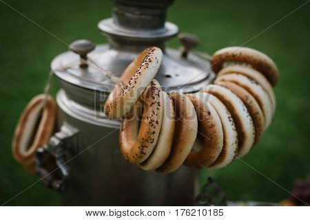A Samovar With A Bunch Of Bagels Hanging On It