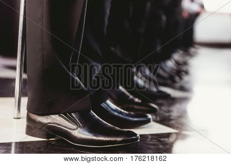 Elegant and stylish mens black shoes standing in one line