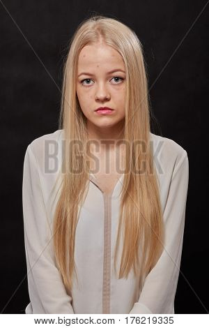 pimply skin blond girl on black background