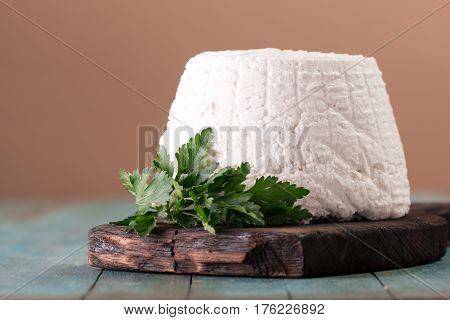 A Fresh Ricotta Cheese With Parsley Leaf On Wooden Table, Italian Food