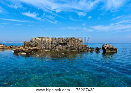 Rocky coast of Tabarca island. Turquoise clear water of Mediterranean Sea. Idyllic scene