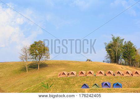 Dome tents on camping site on the mountain at Doi Samer Dao in Nan province Thailand evening sunlight