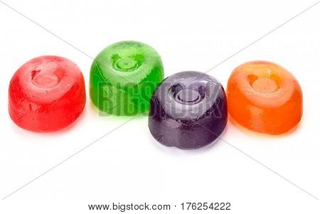 Four colorful fruit hard sugar candies,  boiled sweeties or sugar plums isolated on white background cutout