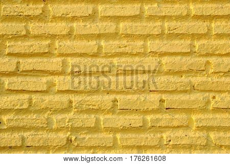 The yellow wall from bricks for background.