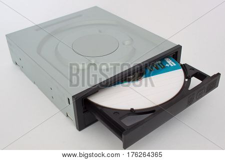 Opened CD - DVD drive with a black cap and disk inside. Isolated.