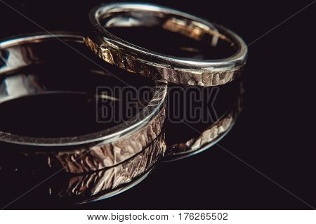 Hammered golden weddin rings. macro. sunsine sparkle