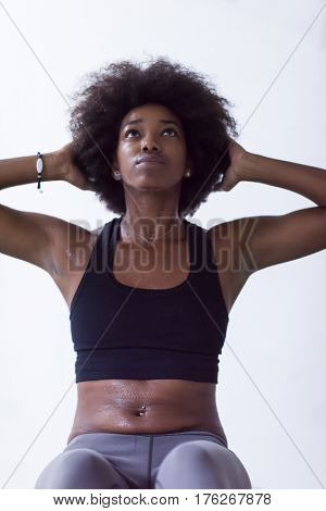 young fit african american woman doing sit ups in fitness studio at the gym.Abdominal exercises Sit up