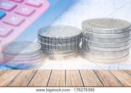 Double exposure coins with calculator Saving money Empty wood table top Economy Investment and Saving Concept.