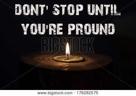 Dont' Stop Until You're Pround - White Candle With Dark Background - In A Wooden Candlestick