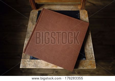 The book is an old leather cover rests on a vintage floor in the room