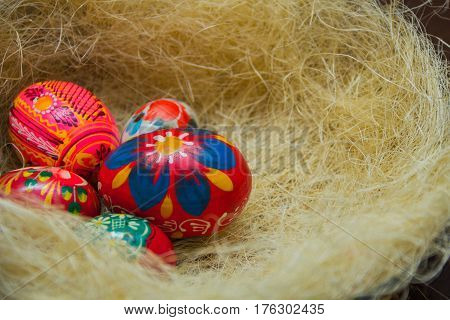 Easter eggs in the nest of sisal. Easter decorating idea. Closeup.